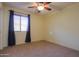 Bright bedroom with neutral walls and ceiling fan at 19572 N Sandalwood Dr, Maricopa, AZ 85138
