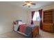 Bedroom with wood furniture, carpet flooring, and window coverings at 19572 N Sandalwood Dr, Maricopa, AZ 85138