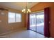 Dining area with access to the backyard patio through sliding glass doors at 19572 N Sandalwood Dr, Maricopa, AZ 85138
