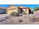 One-story home with desert landscaping and a two-car garage at 19572 N Sandalwood Dr, Maricopa, AZ 85138