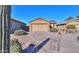 Single story home with a two-car garage and desert landscaping at 19572 N Sandalwood Dr, Maricopa, AZ 85138