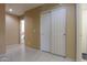 Hallway with tiled floor and closet with double doors at 19572 N Sandalwood Dr, Maricopa, AZ 85138