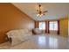 Bright living room featuring tile floors and a ceiling fan at 19572 N Sandalwood Dr, Maricopa, AZ 85138
