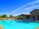 Resort-style pool with a community clubhouse and playground at 19572 N Sandalwood Dr, Maricopa, AZ 85138