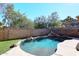 Inviting backyard pool with a rock waterfall feature at 20031 N 22Nd Pl, Phoenix, AZ 85024