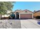 House exterior features a two-car garage and a rock garden at 20031 N 22Nd Pl, Phoenix, AZ 85024