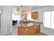 Open kitchen area with granite countertops, wood cabinets, and an island counter space at 20031 N 22Nd Pl, Phoenix, AZ 85024