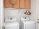 Laundry room with washer, dryer, and wooden cabinets at 20031 N 22Nd Pl, Phoenix, AZ 85024