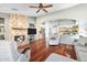 Inviting living area showcases a stone fireplace, hardwood floors, and an open layout to the kitchen at 20967 N 99Th Ln, Peoria, AZ 85382