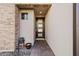 Inviting entryway with dark brown door and stone accent wall at 2357 W Gloria Ln, Phoenix, AZ 85085