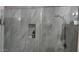Walk-in shower with marble tile surround and glass enclosure at 2511 W Queen Creek Rd # 377, Chandler, AZ 85248