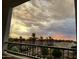 Scenic sunset view from the balcony with palm trees and nearby buildings at 2511 W Queen Creek Rd # 377, Chandler, AZ 85248