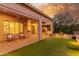 Landscaped backyard with covered patio and lighting at 2562 N 169Th Ave, Goodyear, AZ 85395