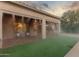 Backyard with covered patio, misting system, and artificial turf at 2562 N 169Th Ave, Goodyear, AZ 85395