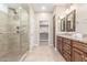 Elegant bathroom with double sinks, granite countertops, and a large walk-in shower at 2562 N 169Th Ave, Goodyear, AZ 85395