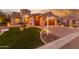 Gorgeous home exterior with a two-car garage and lush landscaping at 2562 N 169Th Ave, Goodyear, AZ 85395