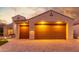 Well-lit two-car garage with attractive brick paver driveway at 2562 N 169Th Ave, Goodyear, AZ 85395