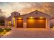Two-car garage, attractive landscaping, and brick paver driveway at 2562 N 169Th Ave, Goodyear, AZ 85395