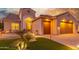Home exterior showcasing a two-car garage and inviting entryway at 2562 N 169Th Ave, Goodyear, AZ 85395
