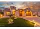 Beautiful two-story home with a three-car garage and manicured lawn at 2562 N 169Th Ave, Goodyear, AZ 85395