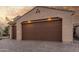 Two-car garage with paver driveway and lighting at 2562 N 169Th Ave, Goodyear, AZ 85395