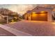 Two-car garage with paver driveway and landscape lighting at 2562 N 169Th Ave, Goodyear, AZ 85395