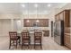 Eat-in kitchen with island seating and stainless steel appliances at 2562 N 169Th Ave, Goodyear, AZ 85395