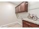 Laundry room with upper cabinets and granite countertop at 2562 N 169Th Ave, Goodyear, AZ 85395