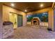 Covered patio with fireplace, built-in grill, and seating area at 2562 N 169Th Ave, Goodyear, AZ 85395