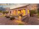 Outdoor patio area with seating, fire pit, and beautiful lighting at 2562 N 169Th Ave, Goodyear, AZ 85395
