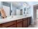Double vanity bathroom with wood cabinets and tiled flooring at 25823 N 122Nd Ln, Peoria, AZ 85383