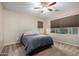 Spacious bedroom with a queen bed and large window at 25823 N 122Nd Ln, Peoria, AZ 85383