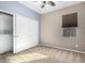 Bright bedroom with double door closet and carpet flooring at 25823 N 122Nd Ln, Peoria, AZ 85383