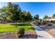 Scenic walking path, lush green grass, and mature trees in a community park setting at 25823 N 122Nd Ln, Peoria, AZ 85383
