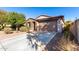 Single-story home with brown brick exterior, two-car garage, and landscaped front yard at 25823 N 122Nd Ln, Peoria, AZ 85383
