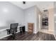 Home office with a desk, chair, and view into kitchen at 25823 N 122Nd Ln, Peoria, AZ 85383