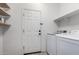 Laundry room with washer, dryer, and built-in shelving at 25823 N 122Nd Ln, Peoria, AZ 85383