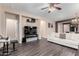 Spacious living room with hardwood floors, sofa, and large TV at 25823 N 122Nd Ln, Peoria, AZ 85383