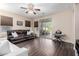 Living room with hardwood floors, leather sofa, and access to backyard at 25823 N 122Nd Ln, Peoria, AZ 85383