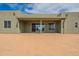 Exterior view of the back of the house featuring a covered patio and neutral paint at 29340 N 231St Ave, Wittmann, AZ 85361