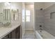 Bathroom featuring double sinks, white countertops, and tile surround bathtub at 29340 N 231St Ave, Wittmann, AZ 85361