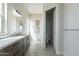 Bathroom featuring modern vanity with cabinet storage and an adjacent water closet with a bright interior at 29340 N 231St Ave, Wittmann, AZ 85361