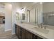 Bathroom featuring double sinks, white countertops, and stylish mirror and lights at 29340 N 231St Ave, Wittmann, AZ 85361