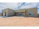 A single-story home with a two-car garage, a covered entryway, and desert landscaping on a sunny day at 29340 N 231St Ave, Wittmann, AZ 85361
