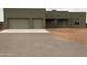 Single story home with three-car garage and desert landscaping at 29340 N 231St Ave, Wittmann, AZ 85361