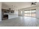 Open-concept living space featuring a kitchen with an island, tile backsplash, and stainless steel appliances at 29340 N 231St Ave, Wittmann, AZ 85361