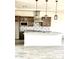 Modern kitchen featuring a large island, stainless steel appliances, and decorative backsplash at 29340 N 231St Ave, Wittmann, AZ 85361