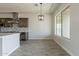 Modern kitchen with gray cabinets, quartz countertops, and pendant lighting in open concept space at 29340 N 231St Ave, Wittmann, AZ 85361