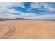 Large empty lot with new homes being constructed in the distance and block fence at 29340 N 231St Ave, Wittmann, AZ 85361