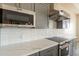 Modern kitchen features stainless steel appliances, quartz countertops, and a subway tile backsplash at 29380 N 231St Ave, Wittmann, AZ 85361